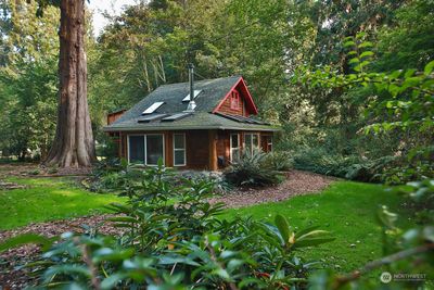 Less than a mile from Langley village, a Storybook cottage on wooded acreage! | Image 1