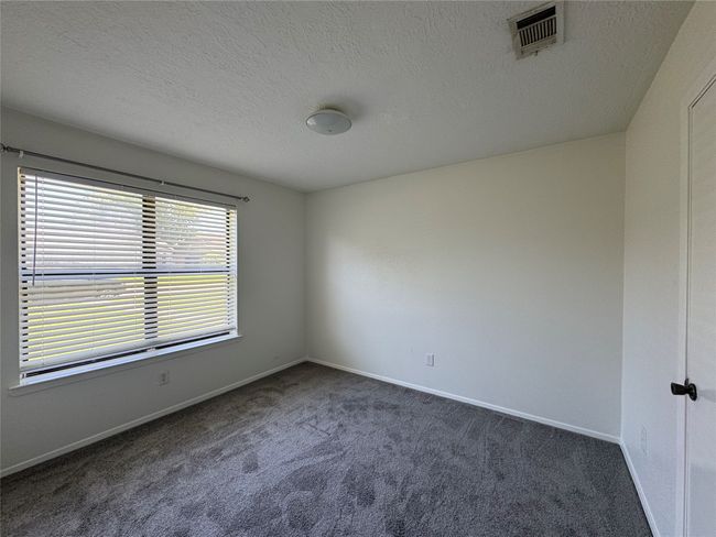 Unfurnished room with carpet flooring, a textured ceiling, and baseboards | Image 15