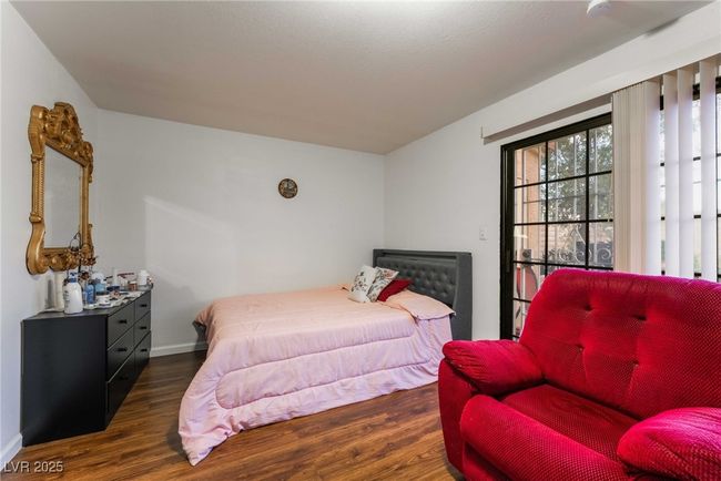 Bedroom with baseboards and wood finished floors | Image 31