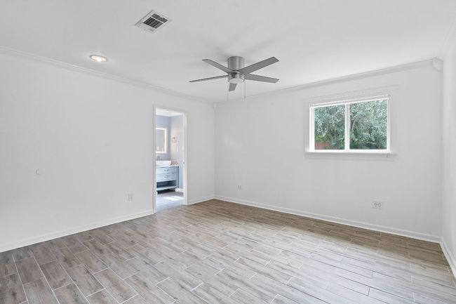 Empty room featuring ornamental molding, ceiling fan, baseboards, and wood finished floors | Image 18