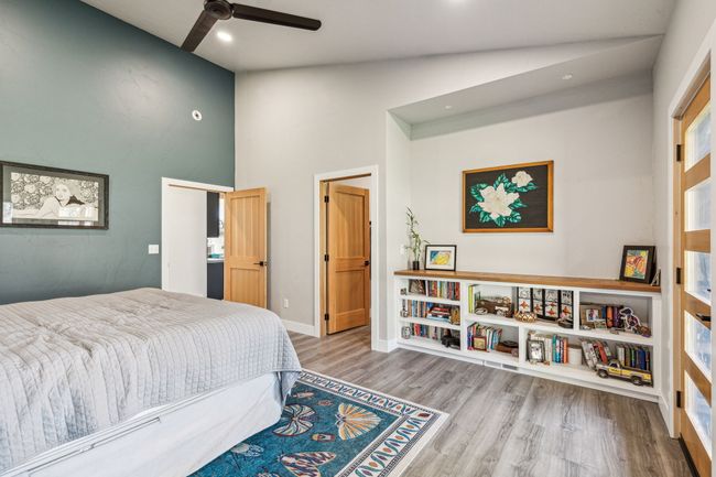 Bedroom with wood finished floors, high vaulted ceiling, recessed lighting, baseboards, and ceiling fan | Image 24