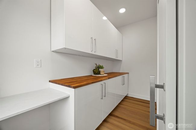 The walk-in pantry has a wood chopping block counter top and a sliding barndoor. | Image 15