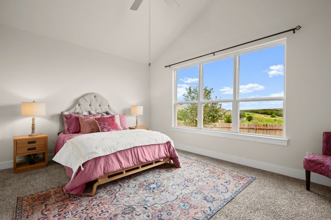 Carpeted bedroom with lofted ceiling and a ceiling fan | Image 10