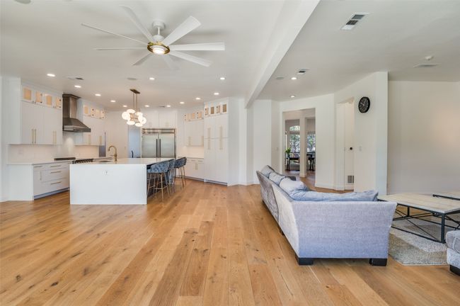 Living area featuring light wood finished floors, visible vents, recessed lighting, and a ceiling fan | Image 4