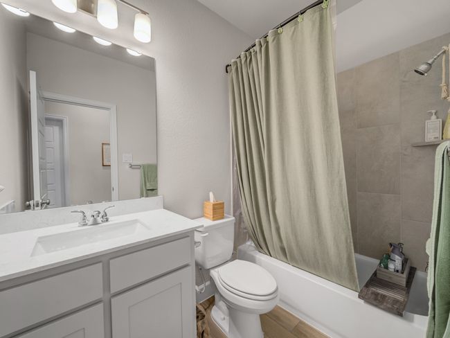 Bathroom with vanity, shower / bath combo with shower curtain, and wood finished floors | Image 22