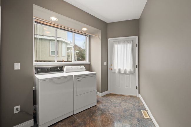 Washroom featuring stone finish flooring, baseboards, washing machine and dryer, and laundry area | Image 22