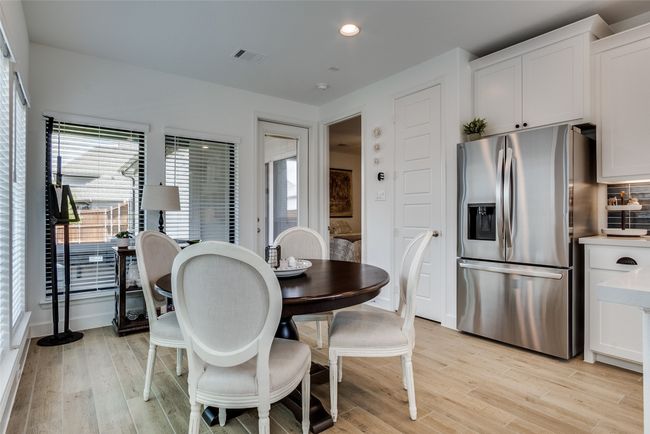 Dining space with light wood finished floors and recessed lighting | Image 19