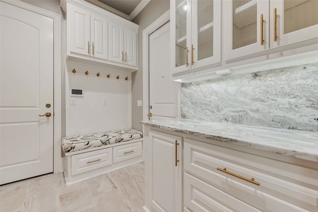 Mudroom featuring marble finish floor and ornamental molding | Image 16