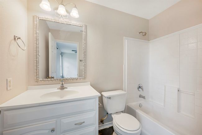 Bathroom featuring vanity and bathing tub / shower combination | Image 20