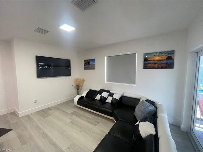 Living room with light hardwood / wood-style flooring | Image 17