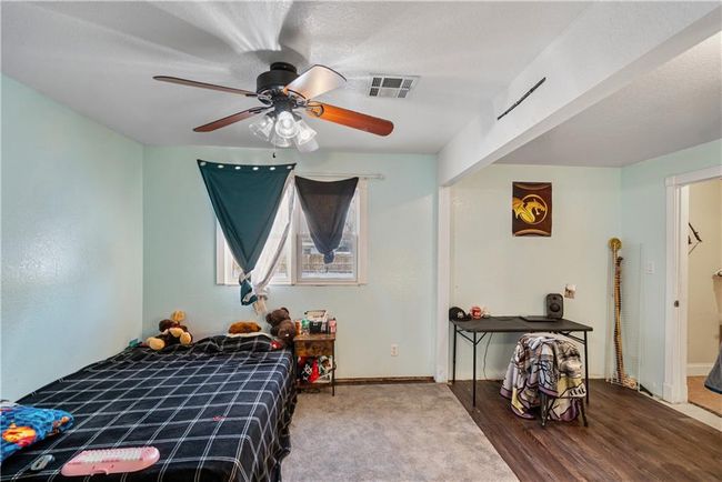 Bedroom featuring wood-type flooring and ceiling fan | Image 40