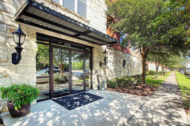 A vibrant building entrance framed by a stylish covered entry. This thoughtful space not only welcomes guests with flair but also provides a cozy shelter from the elements, making every arrival feel special. | Image 23