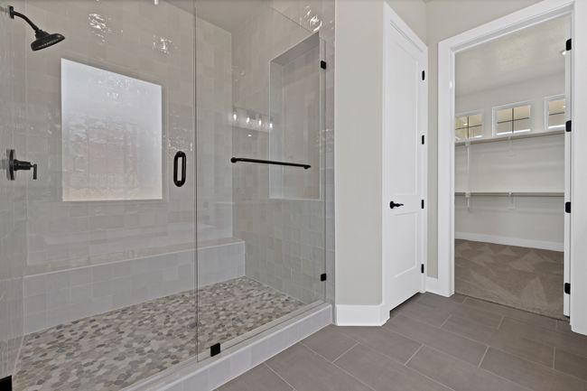 Bathroom featuring a stall shower, tile patterned flooring, and a spacious closet | Image 19