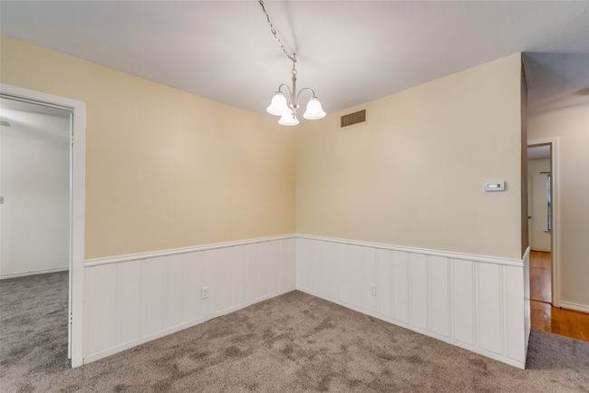 Dining rom featuring a wainscoted wall, visible vents, and an inviting chandelier | Image 11