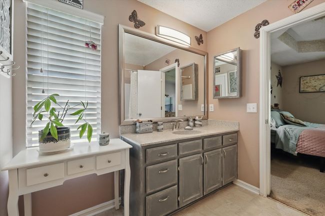 Bathroom featuring a textured ceiling, vanity, and connected bathroom | Image 23