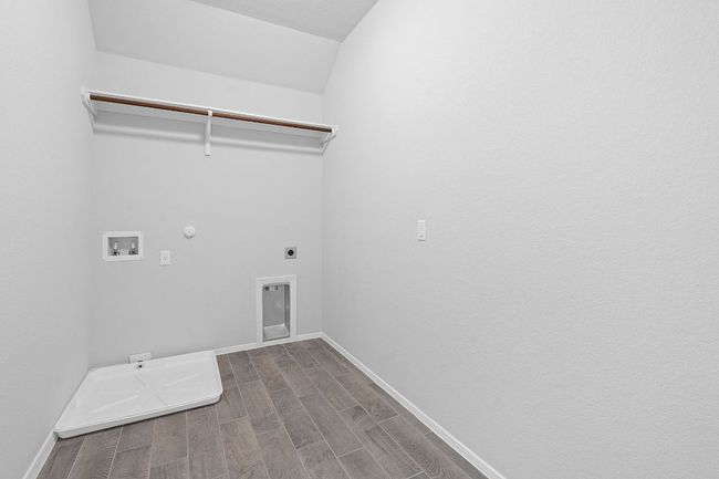 Laundry area featuring washer hookup, electric dryer hookup, dark wood finished floors, and gas dryer hookup | Image 28