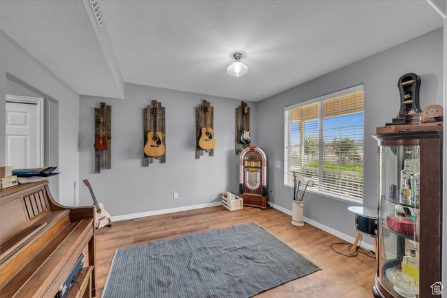 Sitting room featuring baseboards and wood finished floors | Image 25
