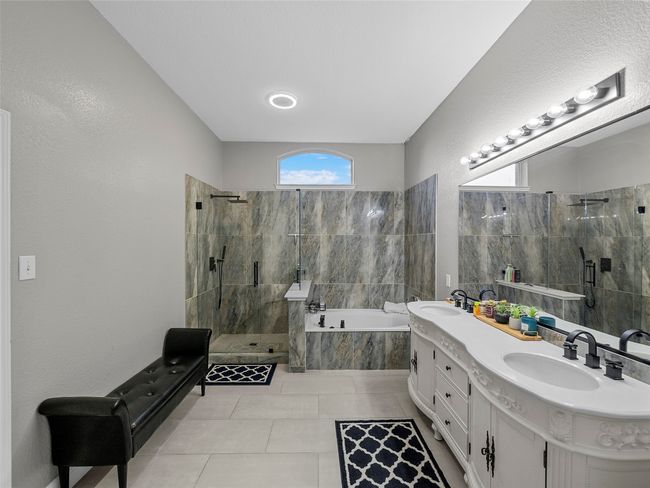 Bathroom with a garden tub, a sink, double vanity, and a stall shower | Image 22