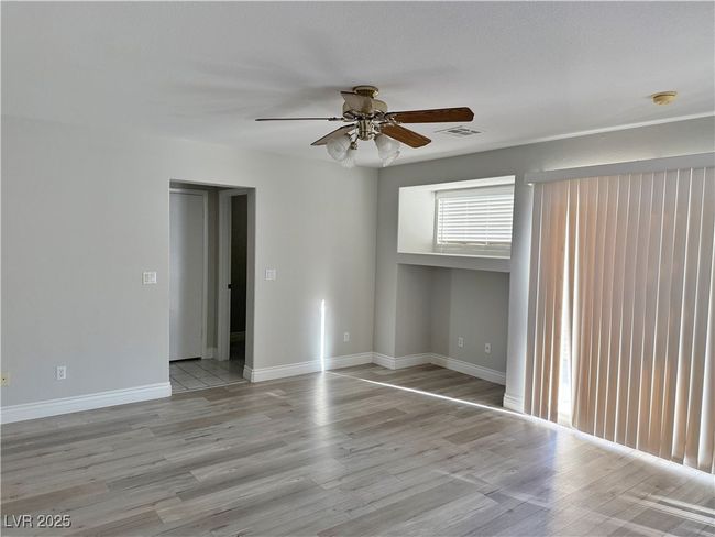 Unfurnished room with visible vents, baseboards, light wood-type flooring, and a ceiling fan | Image 15