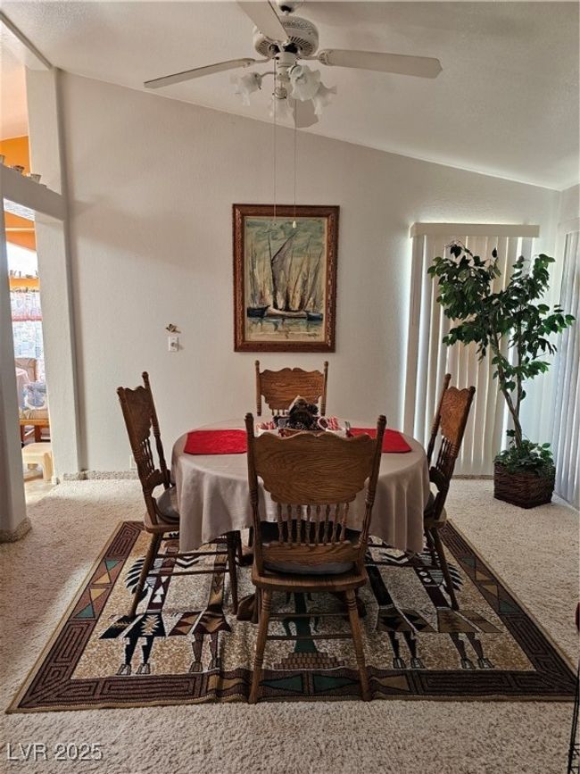Carpeted dining space with ceiling fan | Image 12