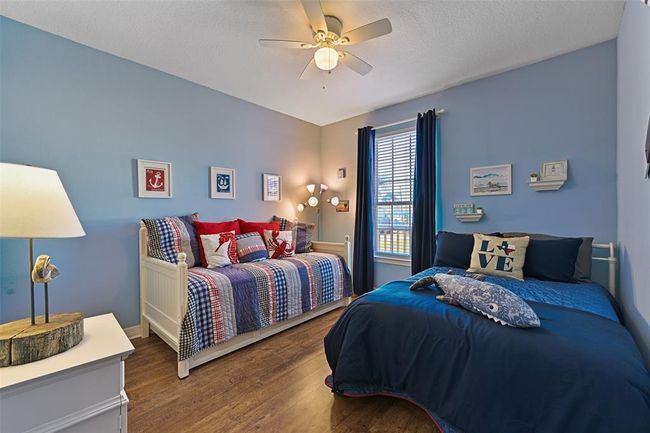 Oversized second main-floor bedroom with a daybed/trundle and queen bed, perfect for accommodating guests. | Image 17