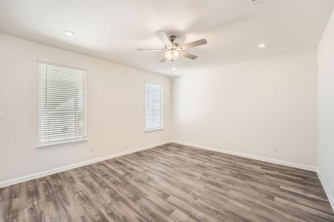 Empty room featuring recessed lighting, baseboards, a ceiling fan, and wood finished floors | Image 6