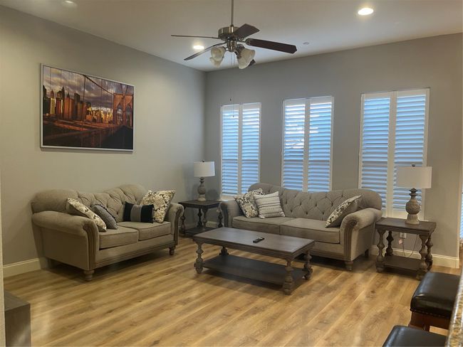 Living room with a ceiling fan, light wood-style floors, and recessed lighting | Image 6