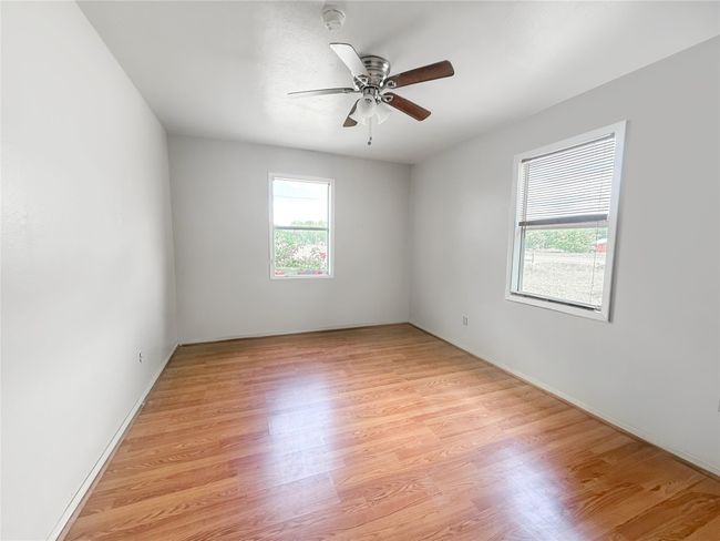 Empty room featuring light wood finished floors and ceiling fan | Image 12