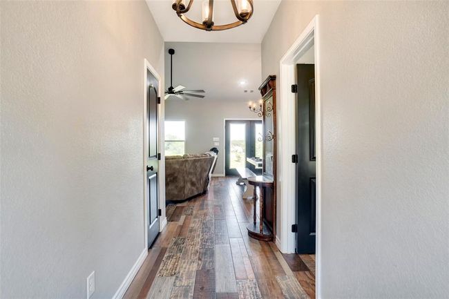 Hall featuring a chandelier and hardwood / wood-style floors | Image 18