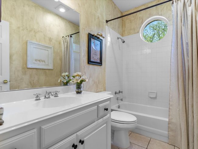 Bathroom featuring vanity, tile patterned flooring, and shower / bath combination with curtain | Image 24