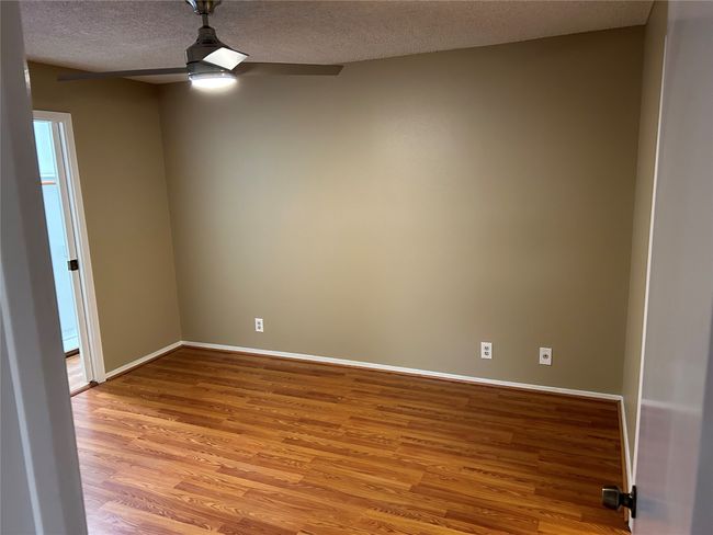 Unfurnished room featuring ceiling fan, light hardwood / wood-style floors, and a textured ceiling | Image 16