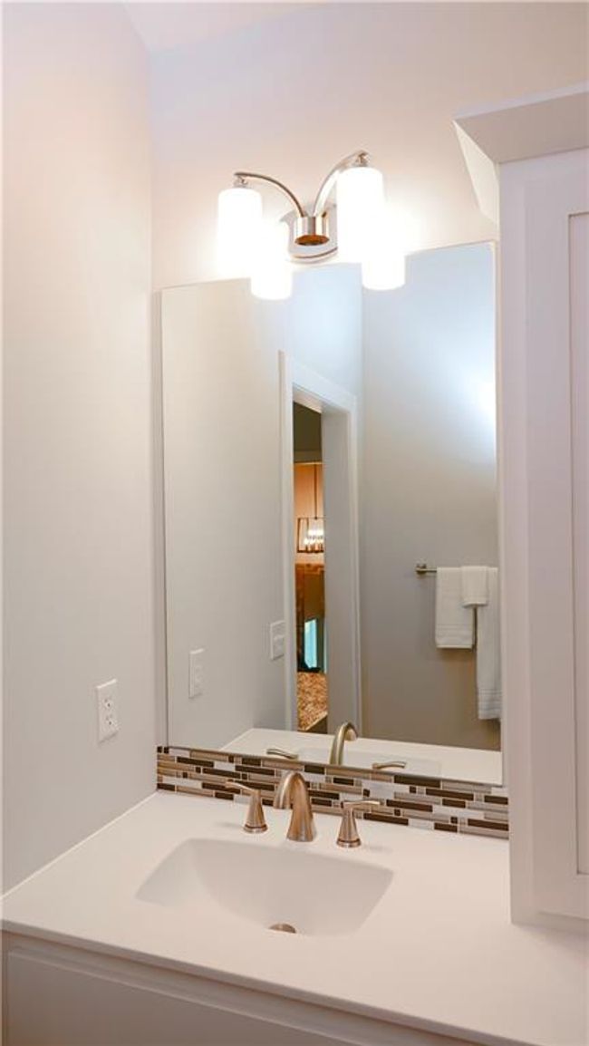Bathroom with vanity and decorative backsplash | Image 38