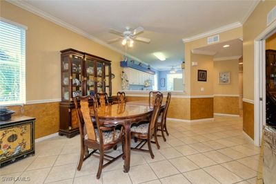 Dining area featuring ceiling fan, light tile patterned floors, and ornamental molding | Image 3