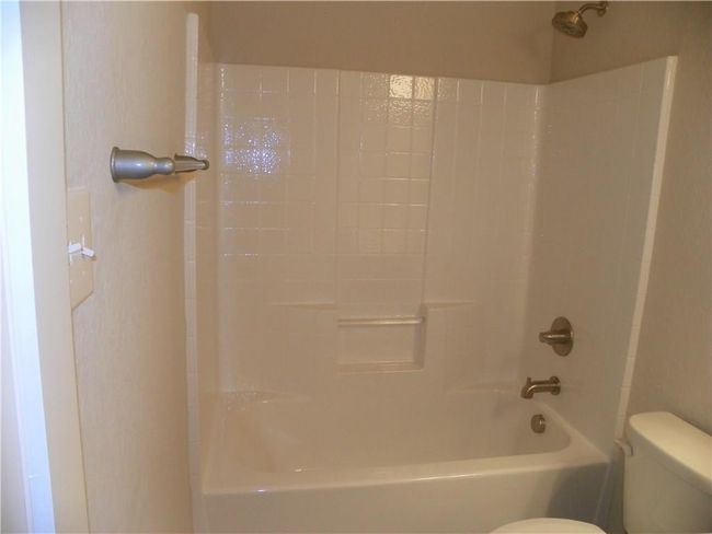 Full bath featuring toilet and bathing tub / shower combination | Image 11