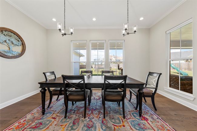 Dining space featuring an inviting chandelier, baseboards, and recessed lighting | Image 12