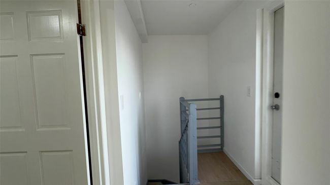 Hallway featuring wood finished floors and an upstairs landing | Image 7