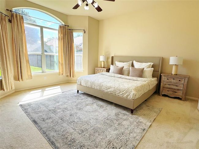 Primary bedroom is large size and comes equipped with a ceiling fan. | Image 16