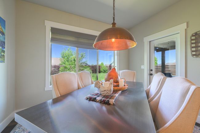 Dining space with healthy amount of natural light, and dark wood finished floors | Image 13