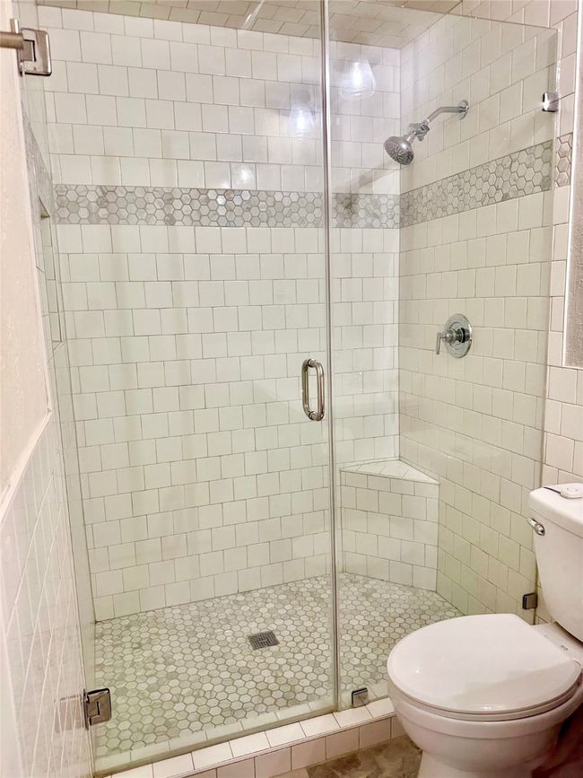 Full bathroom with a shower stall and toilet | Image 25