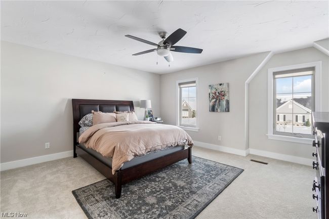 Carpeted bedroom featuring multiple windows and ceiling fan | Image 25