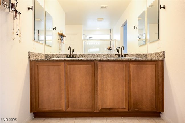 Full bath with visible vents, a sink, double vanity, and a stall shower | Image 26