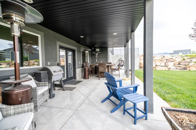 View of patio with french doors, outdoor dining space, and area for grilling | Image 88