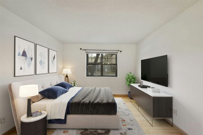 Large primary bedroom, with large window. | Image 10