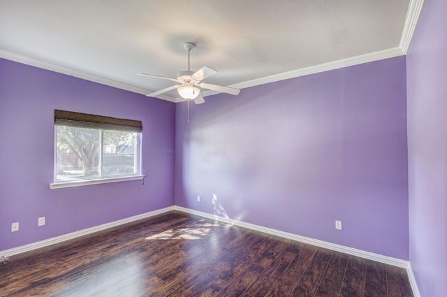 Empty room featuring ceiling fan, dark hardwood / wood-style flooring, and crown molding | Image 11