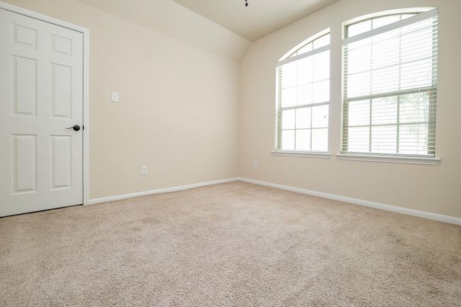 Double arched windows bring morning sunshine and deep night skies into this generous secondary bedroom; any of which may serve as a nursery, hobby room, work out space? It's all up to you. | Image 22