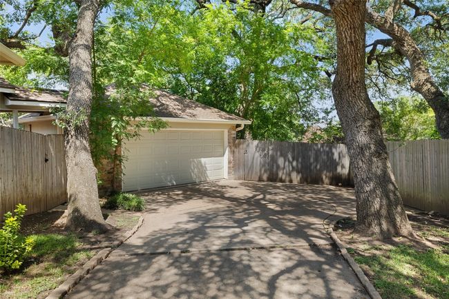 View of patio with fence and a garage | Image 40