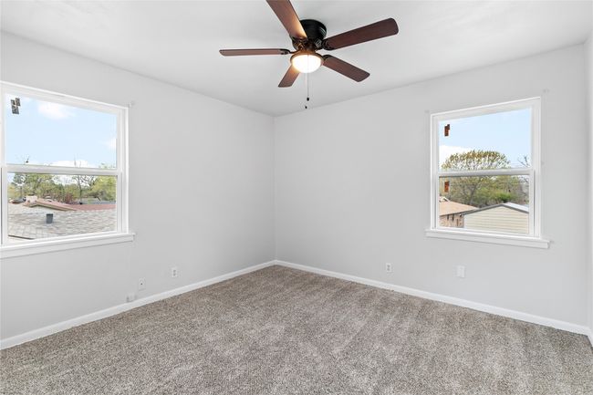 Carpeted empty room with ceiling fan and baseboards | Image 21