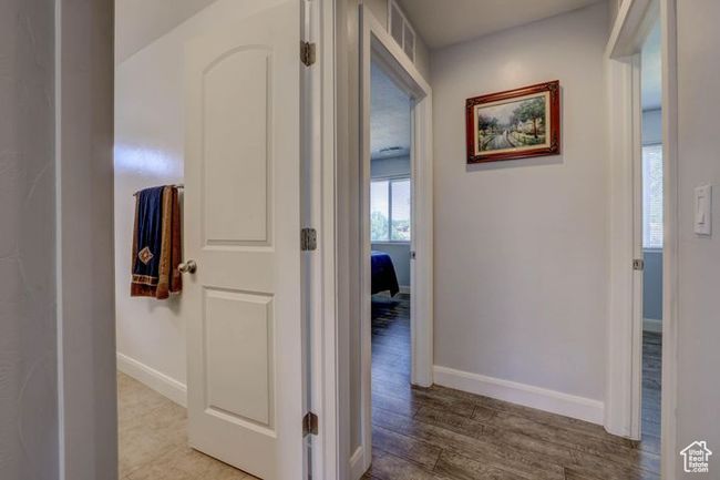 Hallway with baseboards, wood finished floors, and visible vents | Image 19