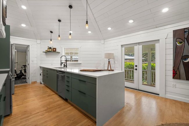 Kitchen with a sink, green cabinetry, dishwasher, and light countertops | Image 10