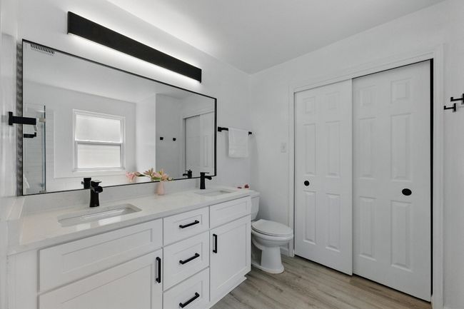 Recent vanities, mirrors, and fixtures elevate the en-suite bathroom, offering a spa-like experience. | Image 17